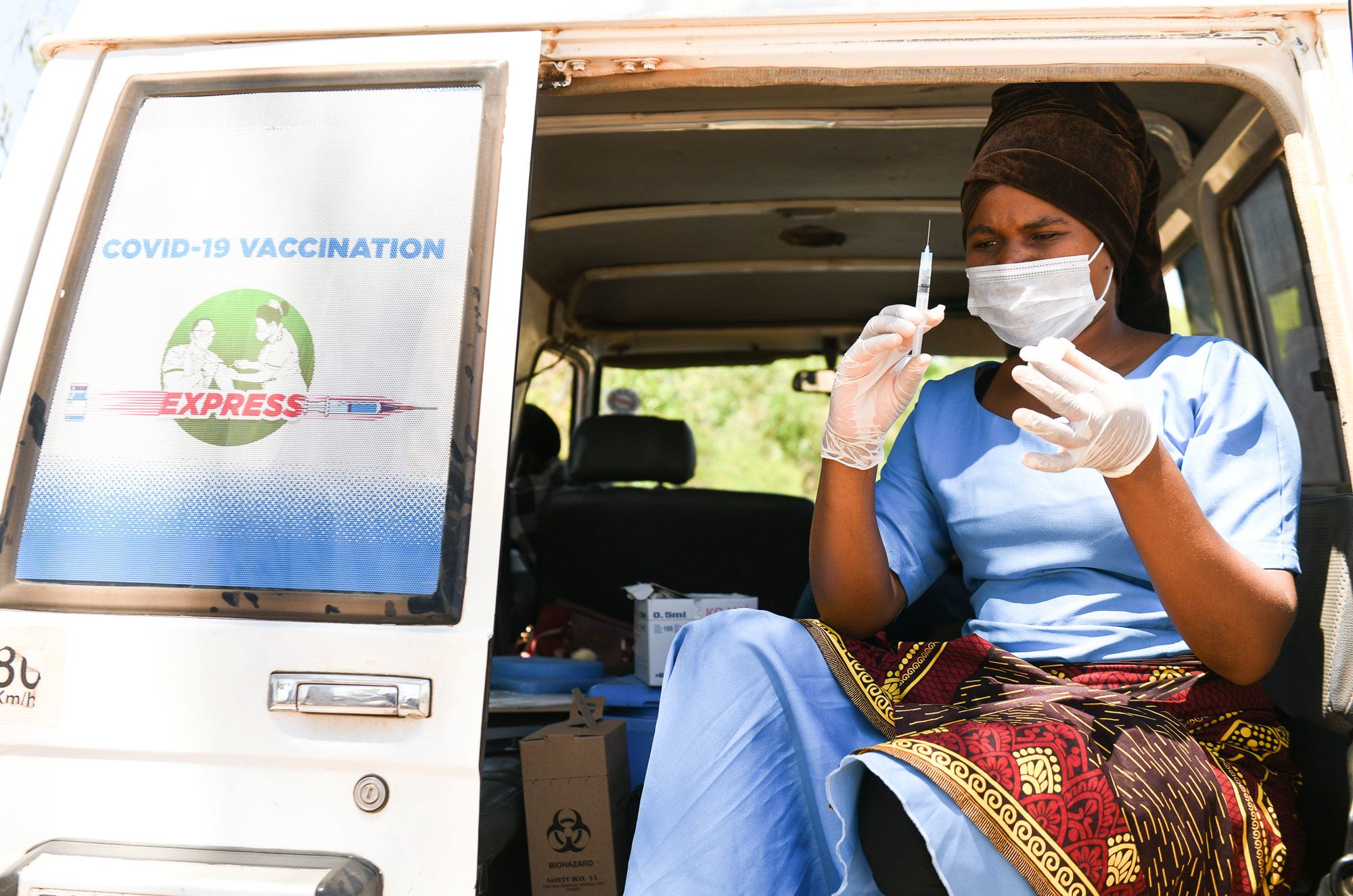 A health worker prepares to administer COVID-19 vaccines at a village in Kasungu, Malawi.