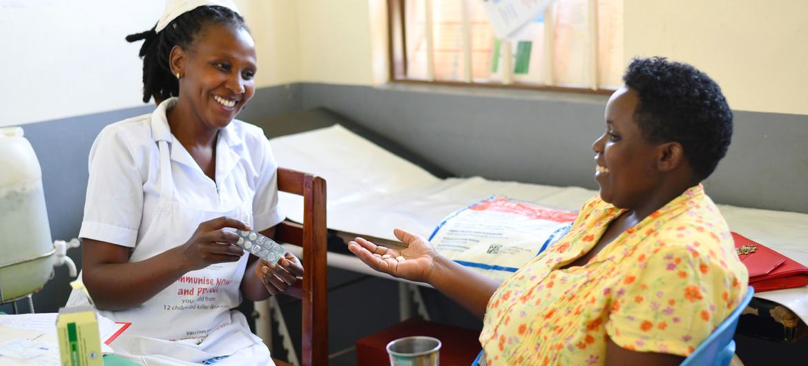 A woman receives malaria prevention medication at health centre in Uganda.