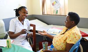 A woman receives malaria prevention medication at health centre in Uganda.