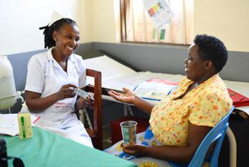A woman receives malaria prevention medication at health centre in Uganda.