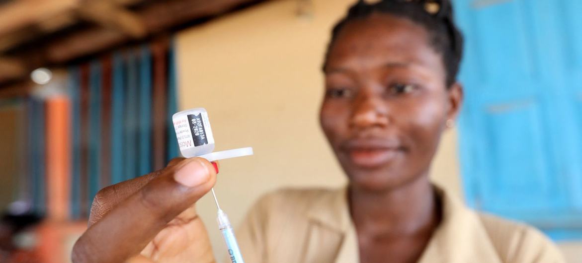 在加纳的大规模疫苗接种活动中，一名卫生工作者手持疟疾疫苗注射器。