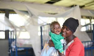 A woman and her baby in Uganda at the Itojo Hospital's pediatric ward, which had no malaria cases due to UNICEF and Ministry of Health interventions, including mosquito nets.