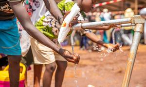 Refugees who have fled violence in DR Congo to Burundi use a water point at a refugee camp in Cibitoke Province.