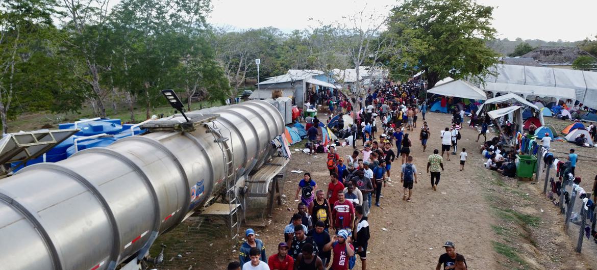 Exhausted migrants take the last steps out of the Darien jungle and into a community.