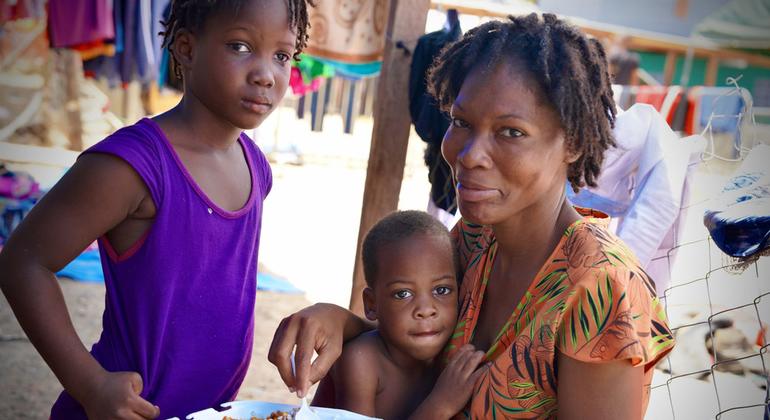 Haitian family eating after crossing the Darien Gap.