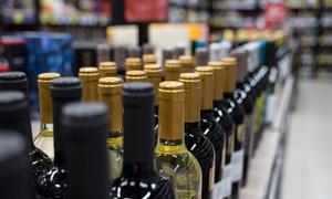 Wine bottles on a supermarket shelf.