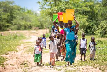 Women and children  collect water from a recently rehabilitated well point in Gwembe Valley, Zambia. (file)