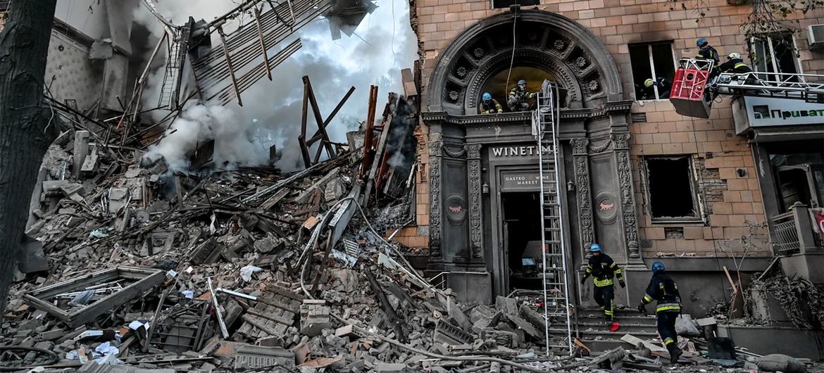 Rescue workers search a building damaged by rockets in Zaporizhzhia, Ukraine.