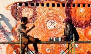 A group of female graffiti artists painted orange murals in Guatemala City in support of UN Women and the UNiTE campaign to End Violence against Women.