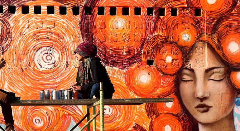 A group of female graffiti artists painted orange murals in Guatemala City in support of UN Women and the UNiTE campaign to End Violence against Women.