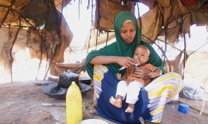 A woman with her one-year-old child who is being treated for malnutrition in Dollow, Somalia. An additional 4.4 million people across the country are at risk of falling into hunger and malnutrition.