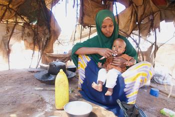 A woman with her one-year-old child who is being treated for malnutrition in Dollow, Somalia. An additional 4.4 million people across the country are at risk of falling into hunger and malnutrition.