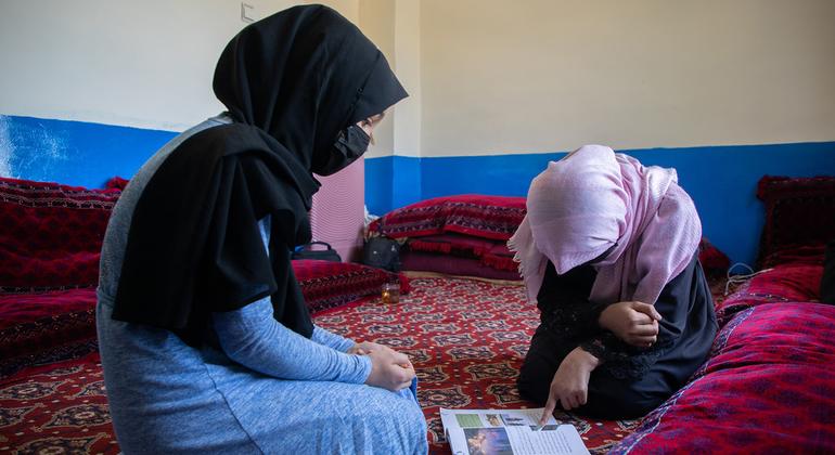 On 8th June 2024 Sharifa* (right), 15 is helping her younger sister Madina*, 13 (left) with her studies. They both have been out of school for almost three years now. Sharifa finished sixth grade and awaits the reopening of the schools so she can continu… On 8th June 2024 Sharifa* (right), 15 is helping her younger sister Madina*, 13 (left) with her studies. They both have been out of school for almost three years now. Sharifa finished sixth grade and awaits the reopening of the schools so she can continu…
