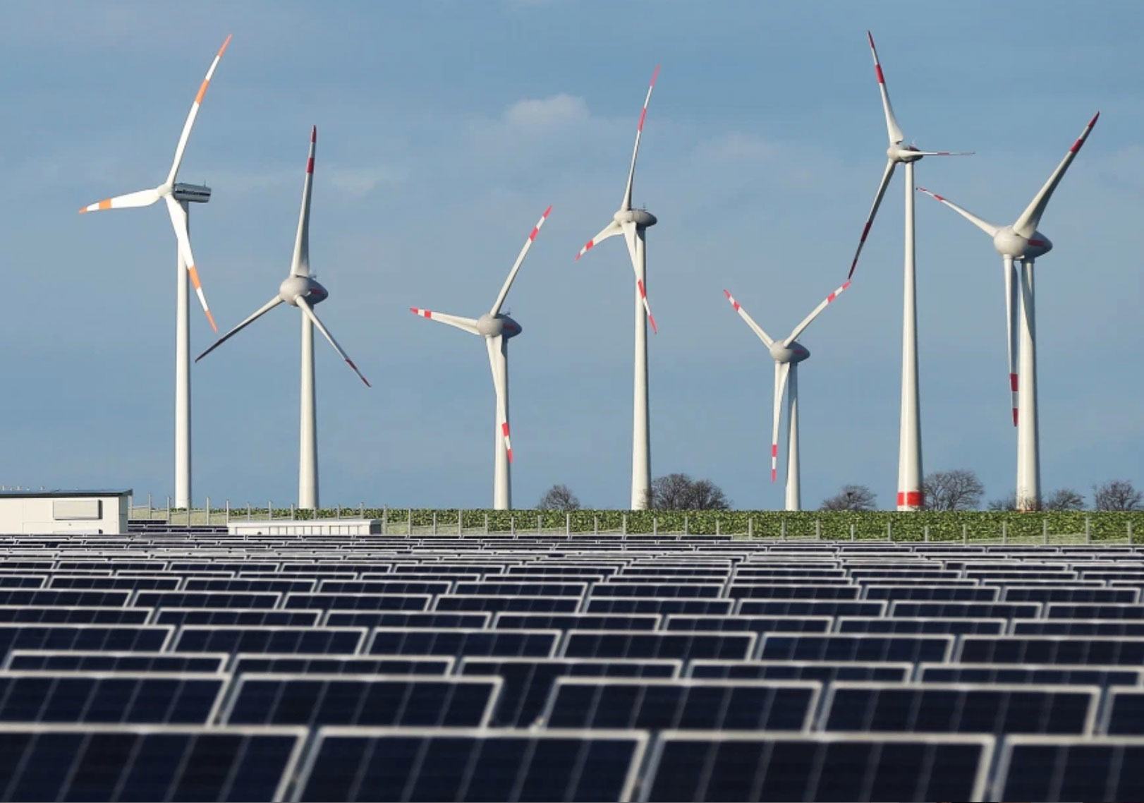 Wind farms and solar panels generate electricity and reduce reliance on coal-powered energy.