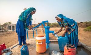 Women use a water pump provided by UNICEF in a village in Sindh province, Pakistan.
