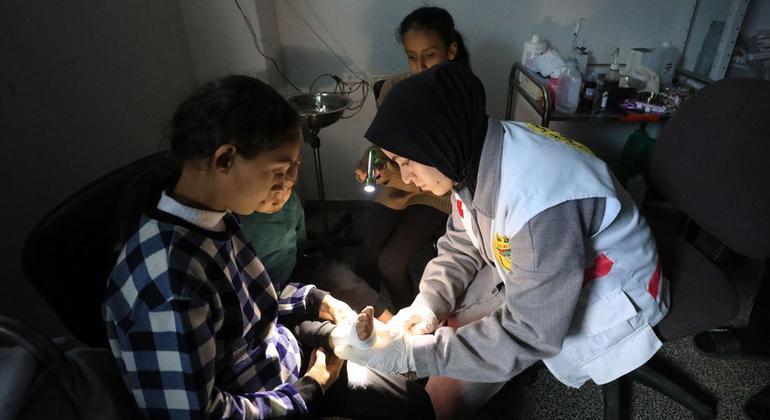 A healthcare worker bandages a child's foot in at a hospital in Gaza.