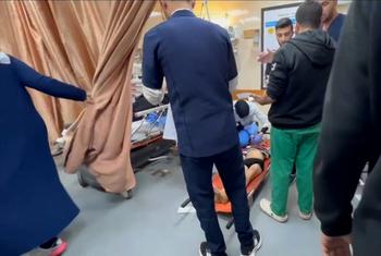 a child being treated for injuries on the floor at Al-Aqsa Hospital in central Gaza.