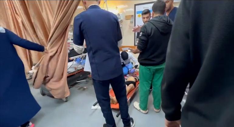 a child being treated for injuries on the floor at Al-Aqsa Hospital in central Gaza.