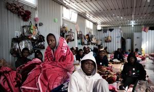 Migrants sit inside a building at a detention centre in Libya. (file)