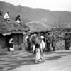 In this photo from 1951, members of the UN Commission for the Unification and Rehabilitation of Korea can be seen visiting a Korean village.