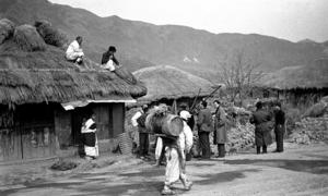 In this photo from 1951, members of the UN Commission for the Unification and Rehabilitation of Korea can be seen visiting a Korean village.