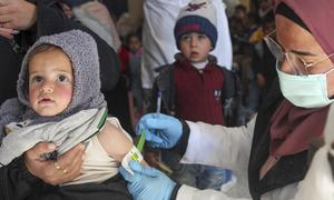 A one-year-old child is screened for malnutrition by a UNICEF-supported health team in Syria.