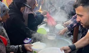 Women in Gaza receiving hot meals.