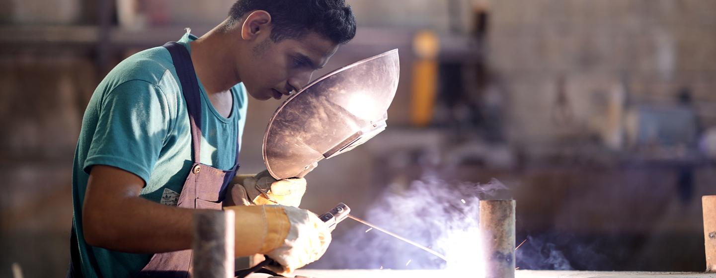 A young unemployed man receives job training in Lebanon.