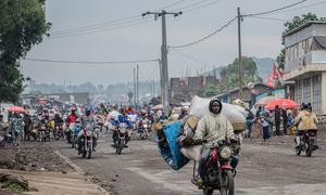 People displaced by the fighting in Goma flee the city.