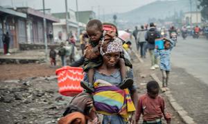 A woman walks through the streets with children in Goma in the eastern Democratic Republic of the Congo.