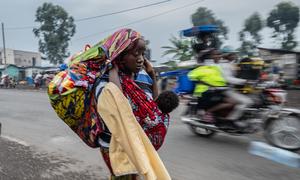 A woman flees from a camp for displaced people in Goma in the eastern DR Congo.