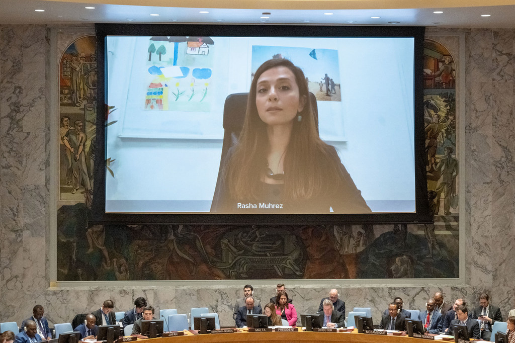 Rasha Muhrez, Response Director at Save the Children, appears on a large screen during a UN Security Council meeting in New York to brief on the situation in Syria.
