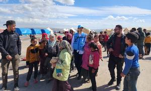 Shirin Yaseen (centre) visits a camp for displaced people in Jindairis in northwestern Syria.