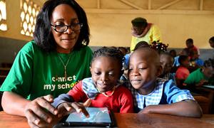 Young girls at a school in Yaoundé, the capital of Cameroon use a tablet during a lesson.