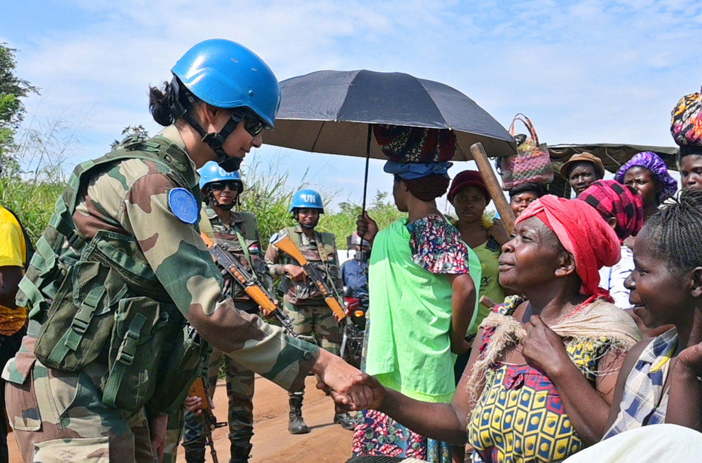 Major Radhika Sen greets local women during a patrol, building trust.