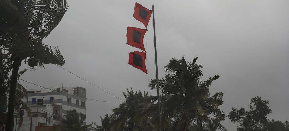 Three flags signifying "great danger" and "severe storm imminent" in village of Panjupara, Bangladesh, as Cyclone Remal is about to make landfall on 26 May 2024.