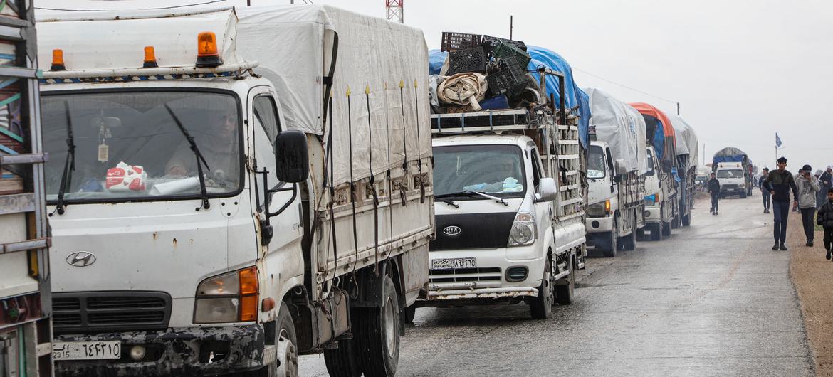 Trucks loaded with the belongings of former residents depart Areesha camp in northeast Syria.