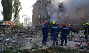 Firefighters work among the rubble of a residential building in Kyiv destroyed in a missile strike on 28 August.