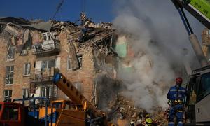 Firefighters work among the rubble of a residential building in Kyiv destroyed in a missile strike on 28 August.