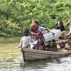 A family that lost their home to the floods transports what remains of their house by dugout canoe in the Far North of Cameroon.