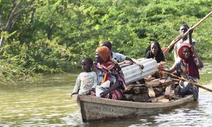 A family that lost their home to the floods transports what remains of their house by dugout canoe in the Far North of Cameroon.