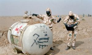 United Nations inspectors measure the volume of nerve agent in a container in Iraq. (file)