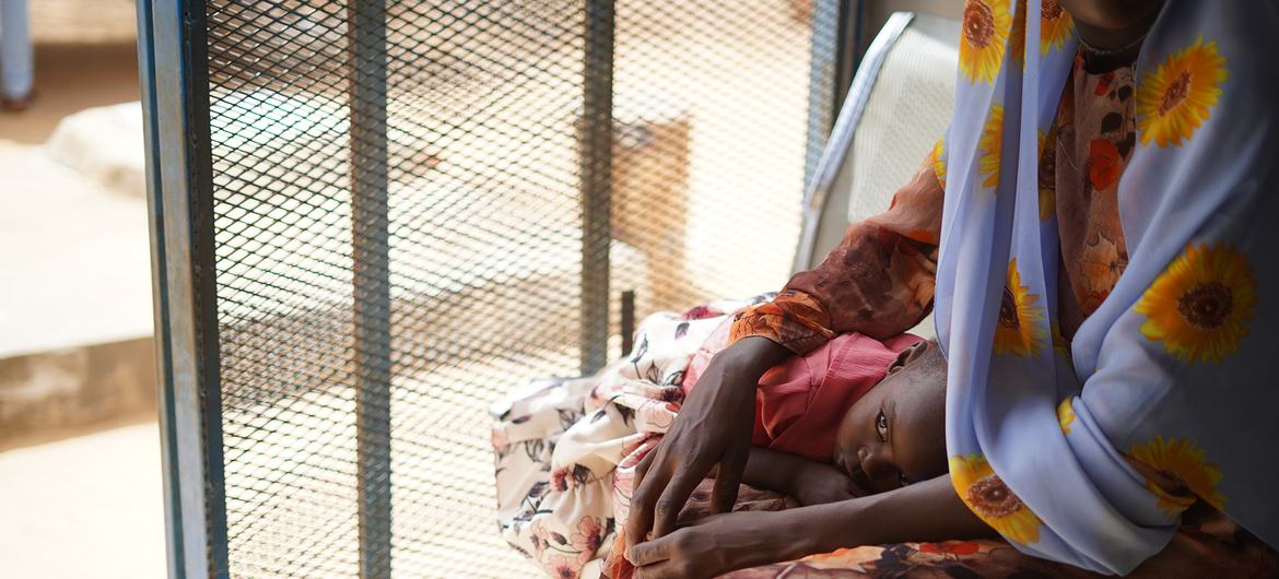 On 2 May 2023, a parent awaits healthcare services at Fashir Reproductive health centre in Sudan. The centre received WASH and health supplies from UNICEF