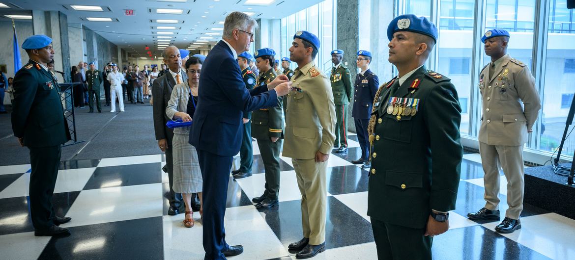 Jean-Pierre Lacroix, Under-Secretary-General for Peace Operations, presents medals during the Peacekeeping Military Police Medal Award Ceremony on the International Day of UN Peacekeepers.