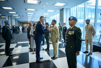 Jean-Pierre Lacroix, Under-Secretary-General for Peace Operations, presents medals during the Peacekeeping Military Police Medal Award Ceremony on the International Day of UN Peacekeepers.