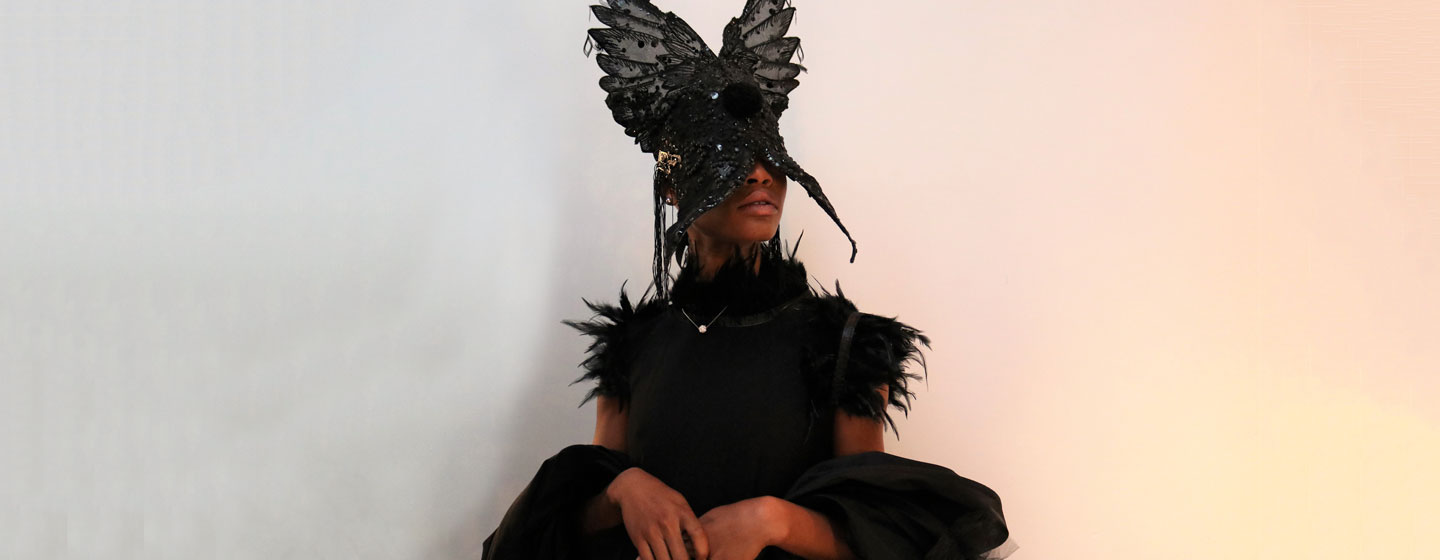 Black swan dress by No Nation Fashion, powered by IOM Bosnia and Herzegovina, presented at 2022 New York Fashion Week event Mask made by Jase King.