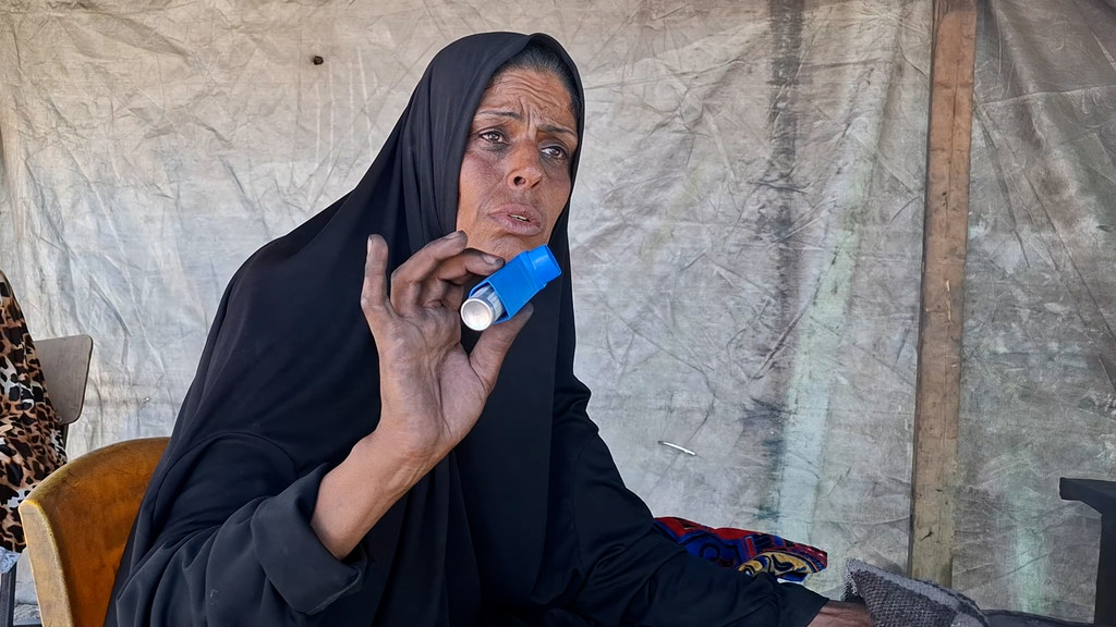 Umm Mohammed Al-Masri, alikimbia kutoka Beit Hanoun kusini mwa Ukanda huo, akifanya kazi katika tanuri ya udongo kuoka mikate na kupika chakula kwa ajili ya watu waliokimbia makazi yao ili kusaidia familia yake. Umm Mohammed Al-Masri, alikimbia kutoka Beit Hanoun kusini mwa Ukanda huo, akifanya kazi katika tanuri ya udongo kuoka mikate na kupika chakula kwa ajili ya watu waliokimbia makazi yao ili kusaidia familia yake.