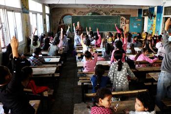 A teacher engaging with students in a classroom in Deir al-Balah Co-educational Primary School, run by UNRWA.