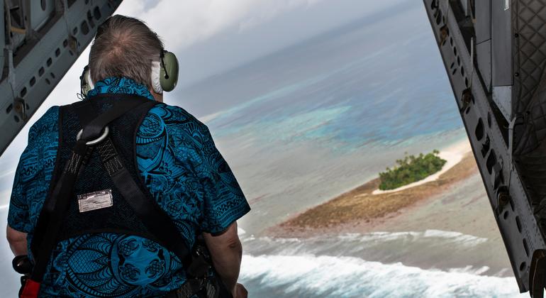 在飞往图瓦卢的途中，秘书长古特雷斯从飞机后部眺望图瓦卢群岛。