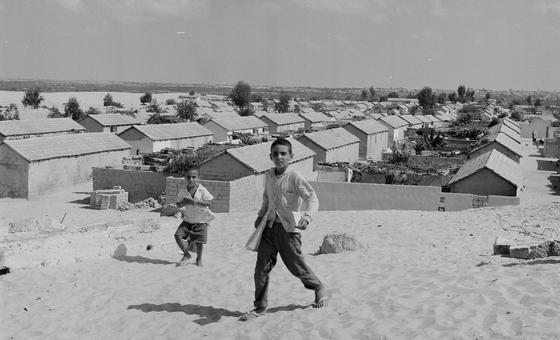 Palestine refugee children on their way to school in UNRWA's Khan Younis camp, built on the stand dunes of the crowded Gaza Strip in 1963.